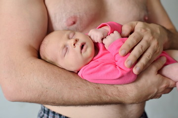 Close up of unrecognizable father holding his newborn baby