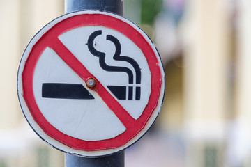 Old No Smoking Label Stick to the pole in the public park