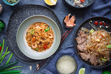 Asian Cuisine, Spicy Asian Beef Noodles, Pho Bo and seafood rice on dark background