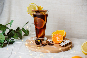 Mulled wine, blue pine tree branch and spices on wooden background