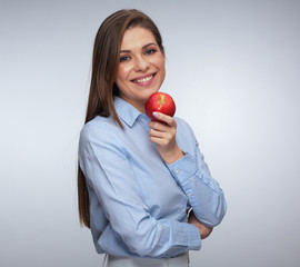 Smiling woman holding red apple.