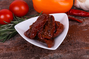 Dried tomatoes in the bowl with olive oil