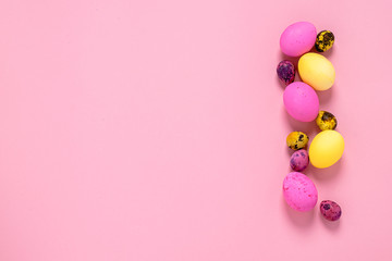 Happy easter concept. Colored eggs on a pink background. Copy space flat layout. Banner with place for advertising.