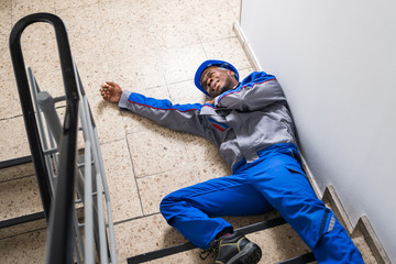 Fototapeta na wymiar Injured Handyman Lying On Floor