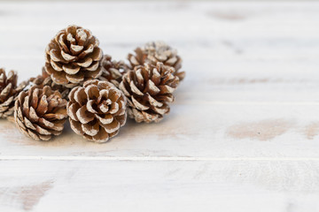 Dried pine balls on a white vintage wooden