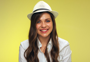 Close up face portrait of smiling woman on yellow background.