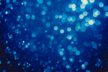 Abstract blue defocused bokeh of lights in dark