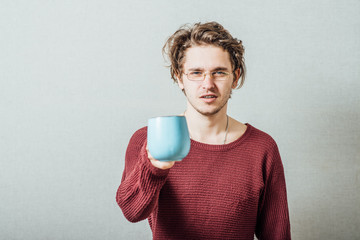 Portrait of handsome young man with cup