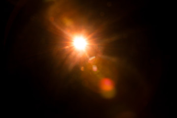 Abstract Natural Sun flare on the black background.