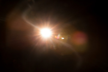 Abstract Natural Sun flare on the black background.