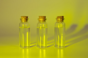 Three glass corked bottles filled with liquid. Background for science and medicine. Virus vaccine.