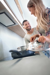 Obraz premium young husband and wife cook dinner together