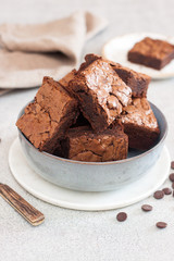 Freshly baked homemeade hocolate chewy brownie in grey bowl.