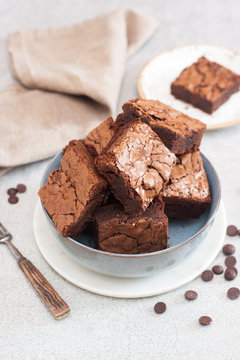 Freshly baked homemeade hocolate chewy brownie in grey bowl.