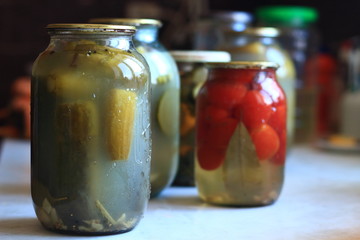 jars of pickles tomatoes and cucumbers