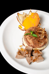 desserts on black background in white plate