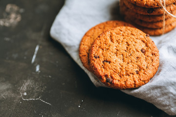 Fresh and healthy cookies with chocolate and seeds on the rustic background. Selective focus. Shallow depth of field.
