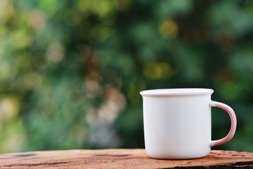 Coffee cup on wooden background and space for text 