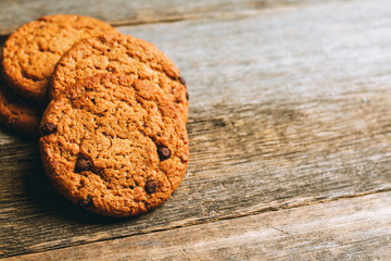 Fresh and healthy cookies with chocolate and seeds on the rustic background. Selective focus. Shallow depth of field.
