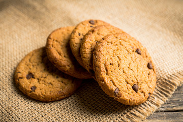 Fresh and healthy cookies with chocolate and seeds on the rustic background. Selective focus. Shallow depth of field.
