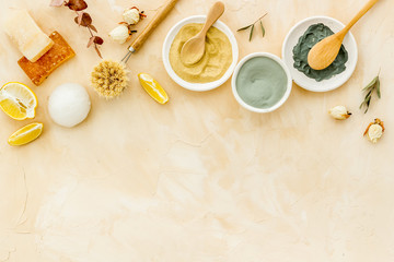 Clay mask in bowl for facial spa on beige background top view copy space