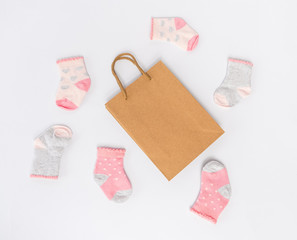 Beautiful new socks for a baby girl and an ordinary paper packet,