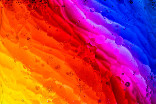 A graphic resource for a background of multi-colored paint spots with the effect of water and oil blurring.