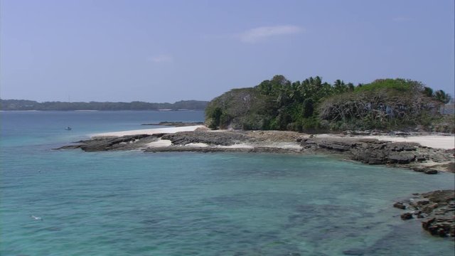 Overflight over a small virgin island with many palm trees and sandy beach in the Las Perlas Archipelago of Panama in the Pacific Ocean