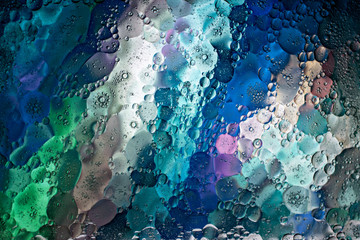 A graphic resource for a background of diagonally slanted multi-colored stripes with the effect of water and oil blurring.