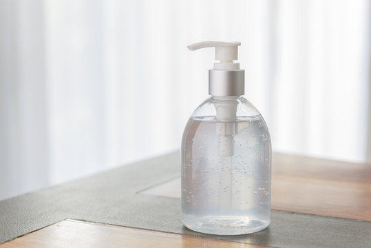 Hand sanitizer bottle or alcohol gel on white wood background for Coronavirus disease (COVID-19) prevention.