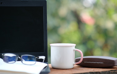 Home office table of laptop computer and blank paper background and copy space