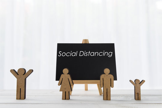 Keep distance steps to protect yourself from Corona virus diseases (COVID-19)(COViD-19),people icon and black board stand on wood white background
