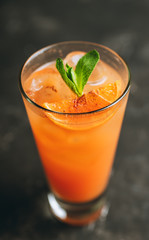 Fresh cocktail with vodka and orange juice on the rustic background. Selective focus. Shallow depth of field.