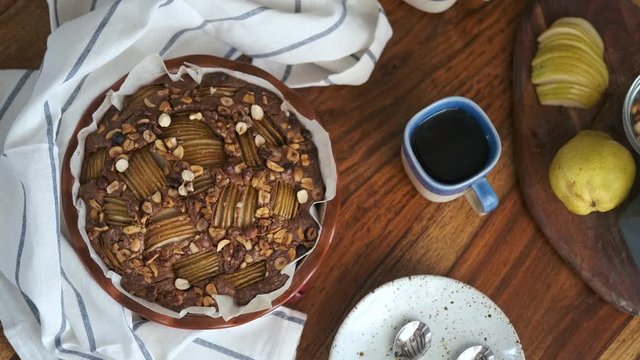 sweet open cupcake with pear and nuts on the table