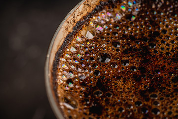 Freshly making coffee in vintage cezve. Selective focus. Shallow depth of field.