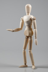 Wooden Mannequin on gray background