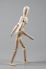 Wooden Mannequin on gray background