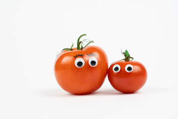 Two tomatoes with funny faces, white background and copy space - 335199541