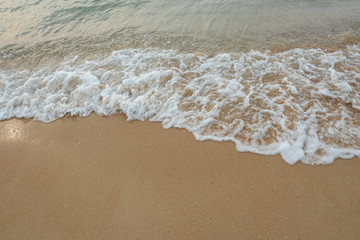 Fototapeta na wymiar Soft waves of the ocean on the sandy beach, summer beach, soft wave bubbles on the sandy beach