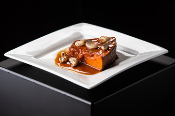 Traditional autumn pumpkin dishes. Roasted baked pumpkin with spices, olive oil. on a white plate. beautiful feed