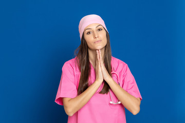 Young doctor with a pink uniform