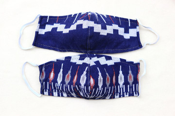 Top view handmade fabric protective masks on white background. Concept for protect from COVID-19/Coronavirus ,saliva, cough, cold,dust, pollution (PM2.5), respiratory disease,virus and bacteria. 