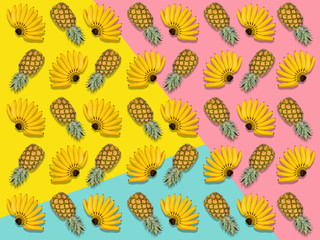 Trendy colorful bananas pineapple pattern. Tropical abstract fruit summer background. Many tropic fruits. Minimal summer food concept. Flat lay, top view