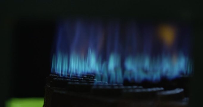 Propane flame buring bight blue on an outdoor burner - close up - slow motion