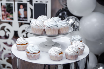 Birthday cupcakes with cream on a plate.