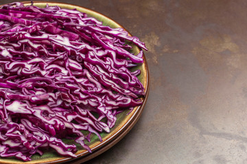 Obraz premium Sliced red cabbage in plate. Fresh vegan food