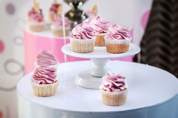 Pink cupcakes lie on a stand