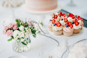 Cupcakes and cake with strawberries and blackberries