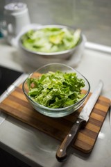 green salad in glass bowl isolated.