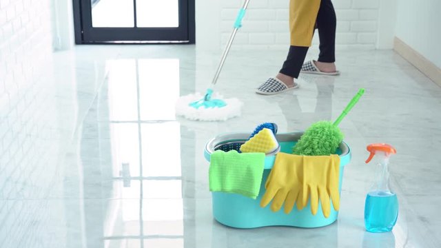 4k video of Woman housekeeper with mop and bucket with cleaning agents for cleaning floor at home, Floor care and cleaning services.